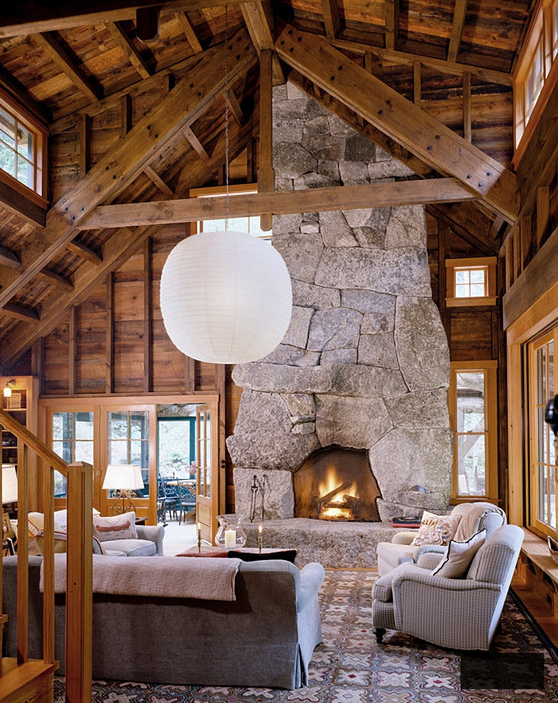 rustic cabin living room with large stone fireplace