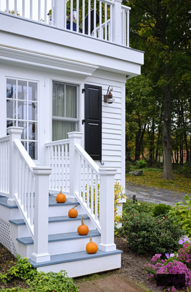 White Fall Porch with Small Orange Pumpkins