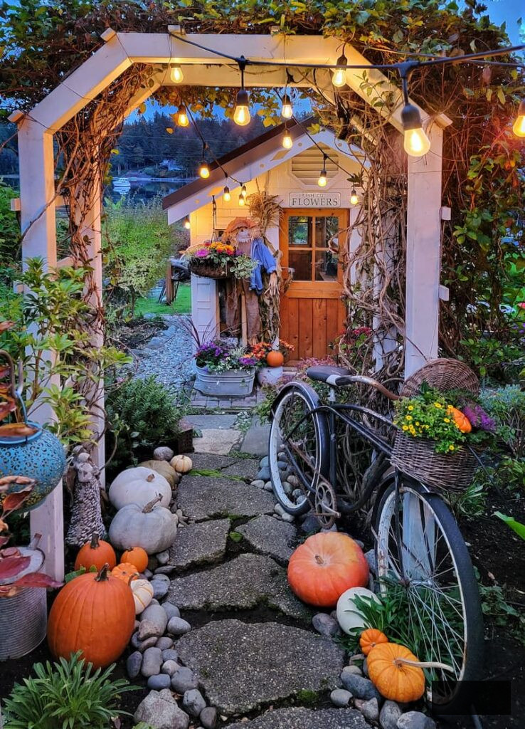 greenhouse and arbor with path decorated for autumn
