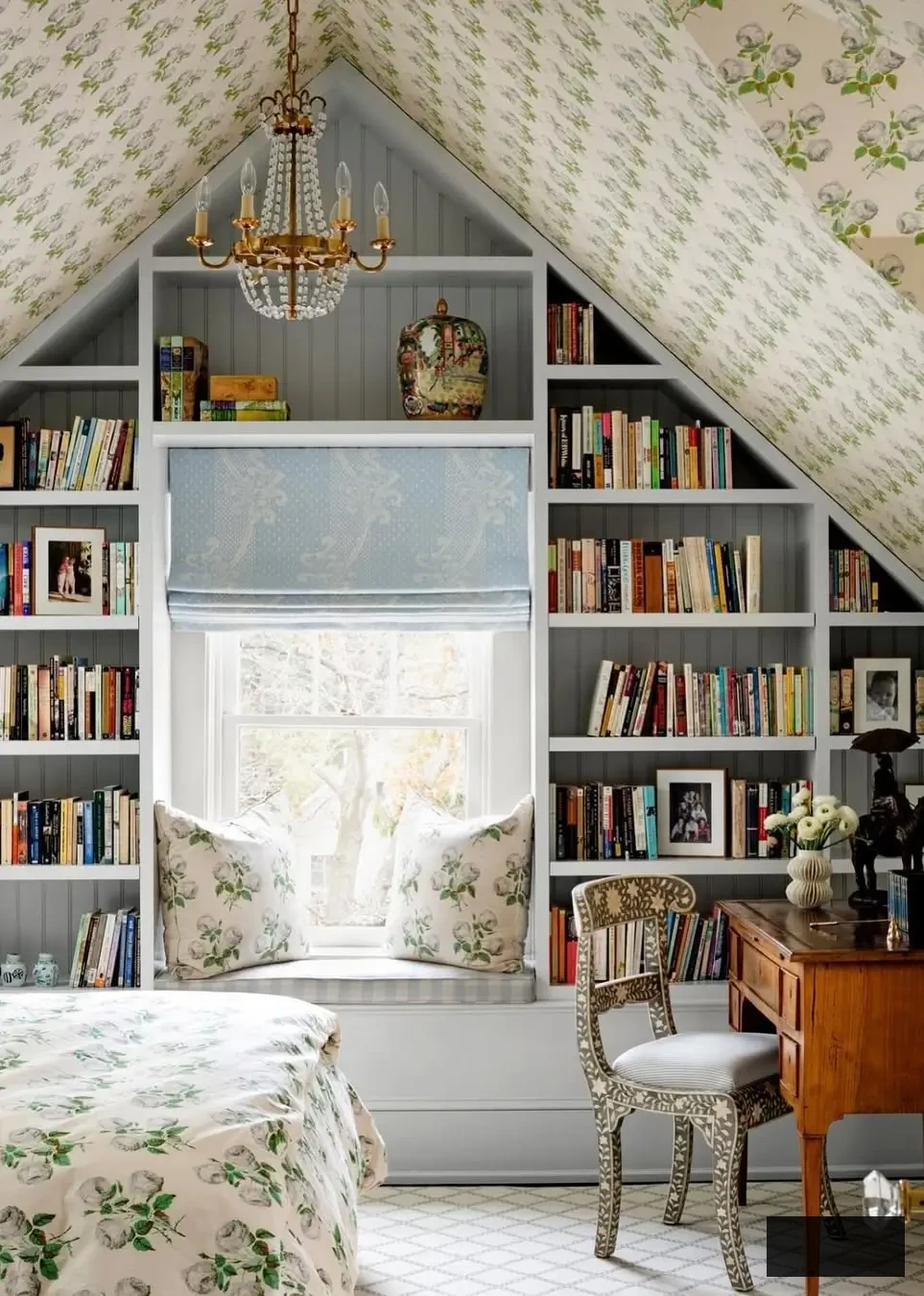 attic bedroom design with wallpaper on ceilings, built-in shelving, and window bench