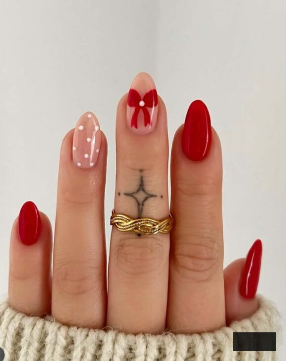 adorable almond christmas nail art with red bow and white polka dot
