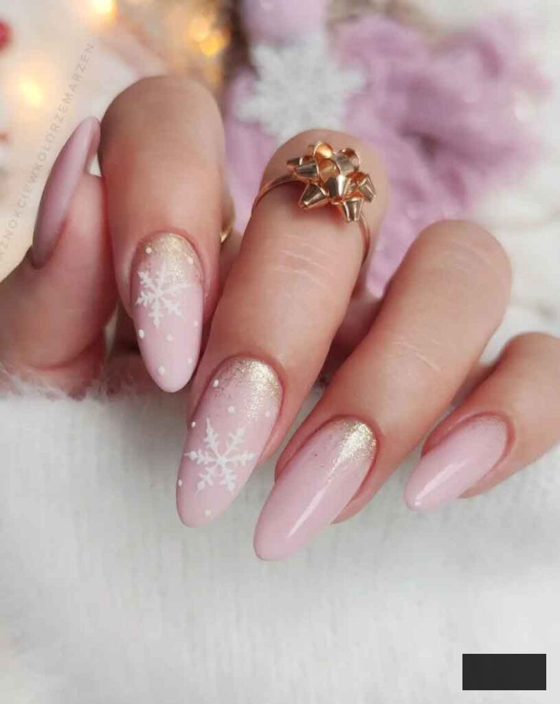 soft pink nail with white snowflake and glitttery gold