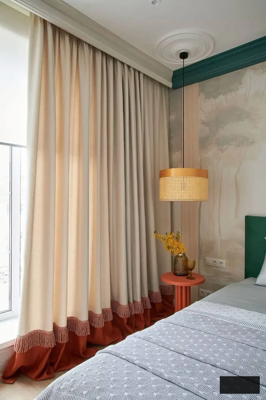 bedroom Cream curtains with a burnt-orange base trim and subtle fringe detailing.