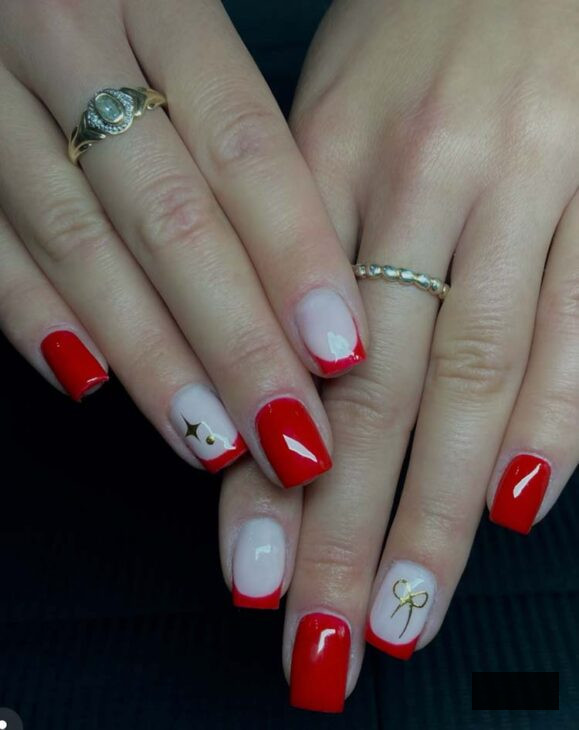 stylish white nails with red tips and gold bow and star design nail art for christmas on square nails