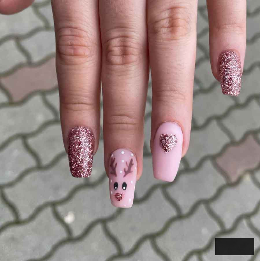 rose gold and pink reindeer christmas nail design