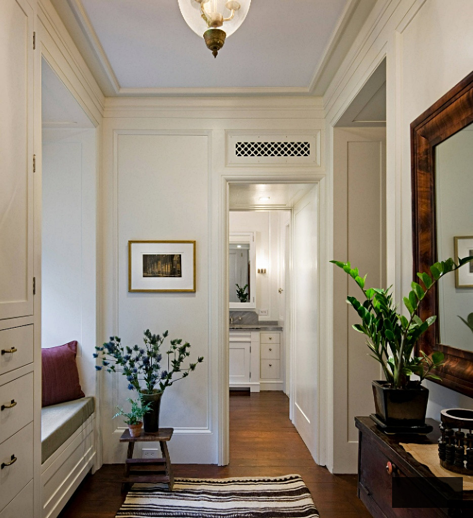 hallway with crown molding and door trim