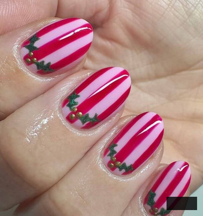 striped pink and red nails with cute holly design