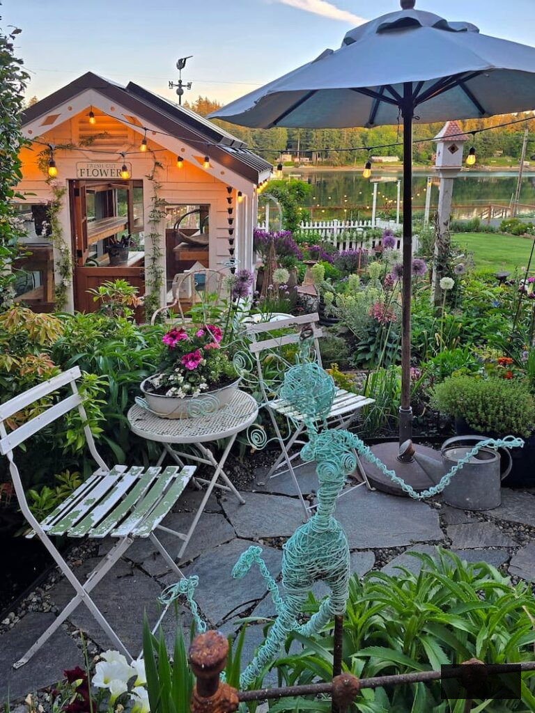stone patio and container garden with greenhouse in the back