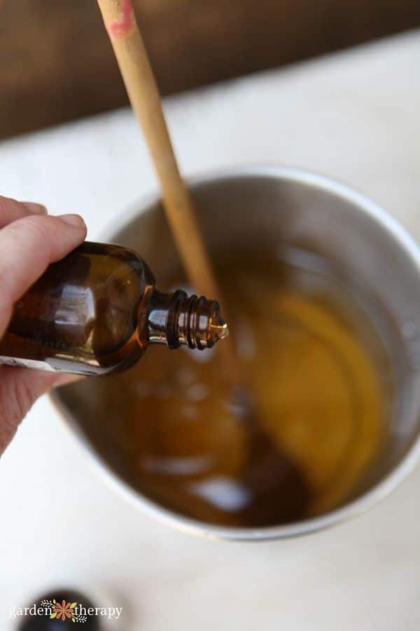 Infusing fragrance oil into molten wax for aromatic homemade candles