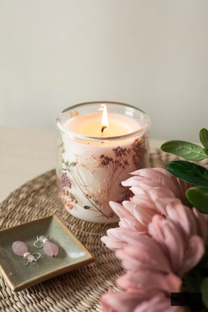 Floral candle embellishment idea featuring pink flowers and cozy styling
