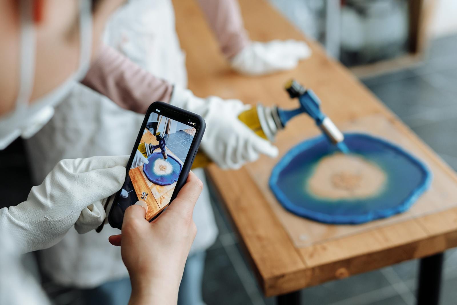Resin art process filmed on a smartphone Landscape photo of a resin art process being filmed on a smartphone while a torch is used. | Sky Rye Design Landscape photo of a resin art process being filmed on a smartphone while a torch is used.