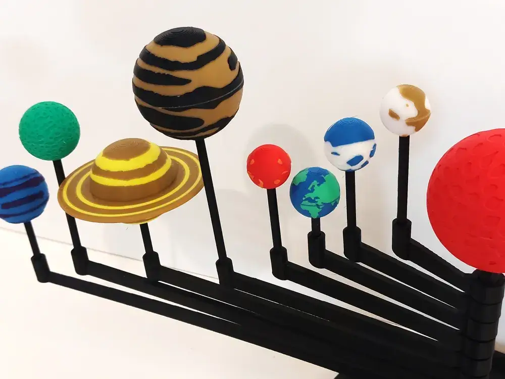 Colorful solar system model with planets mounted on black rods, ideal for educational display.