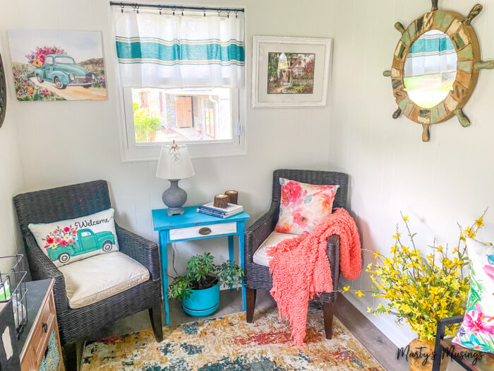Varanda de inverno com almofadas e detalhes em azul-claro e coral