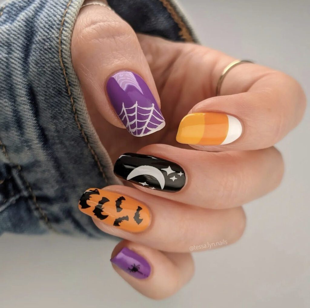 Unhas simples e divertidas de Halloween com morcegos, teias de aranha e bala de goma