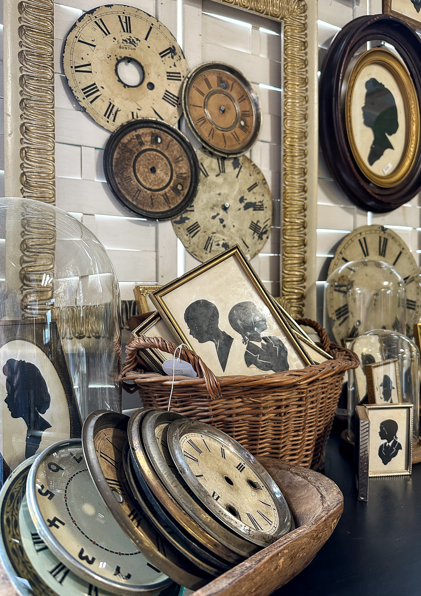 Explore my vintage booth at the Lucketts Spring Market. It's among the trendiest vintage markets on the East Coast! #vintage #vintagedecor antique silhouette clock face exhibition