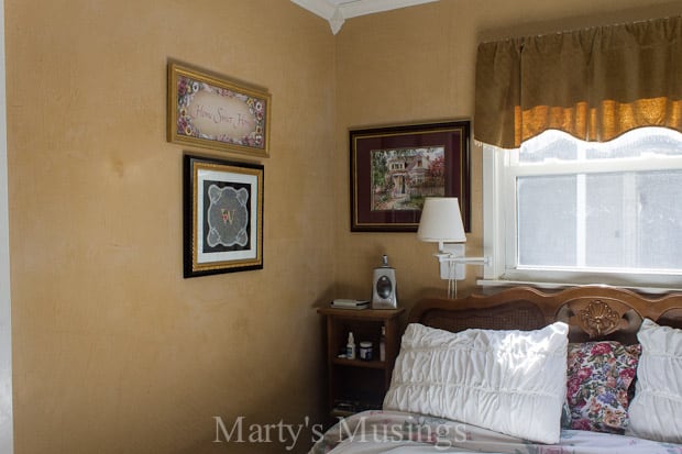 Um quarto com uma cama e uma pintura na parede