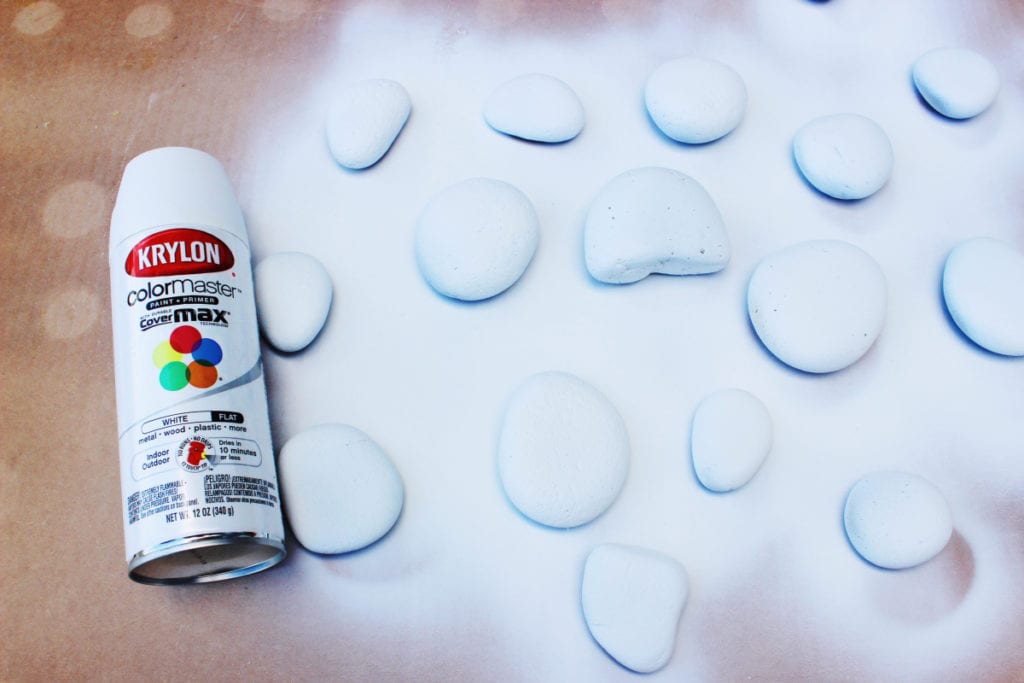 Preparando pedras com tinta branca antes de pintar