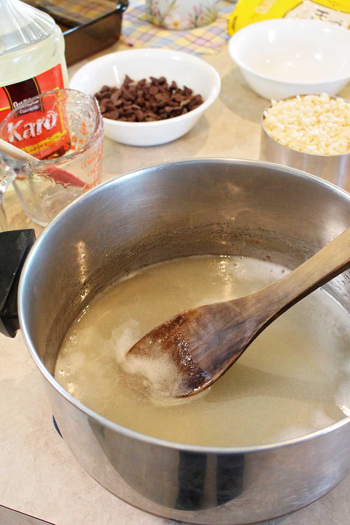 Mistura de xarope Karo em uma panela com outros ingredientes por perto.