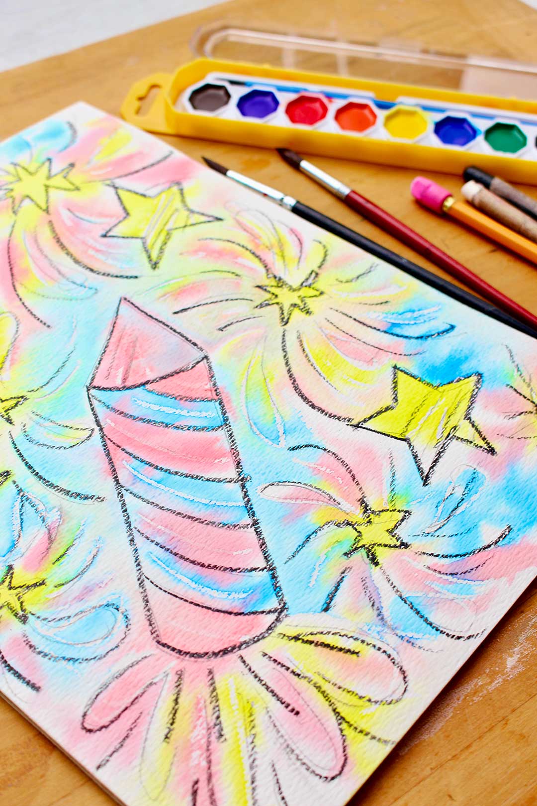 Visão de perto da resistência em aquarela concluída com aquarelas, pincéis e lápis à direita.
