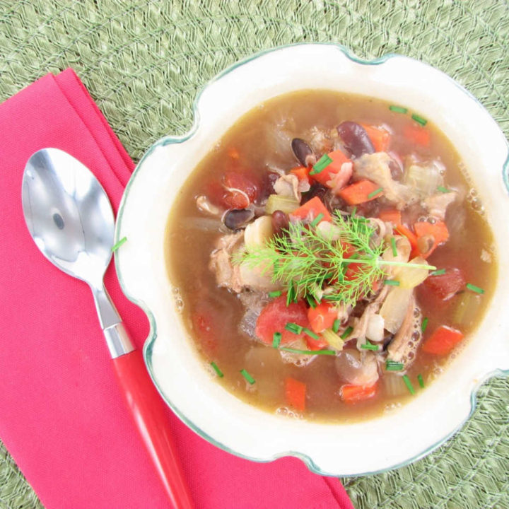 Sopa de Taco de Frango em uma tigela com um guardanapo rosa e colher.