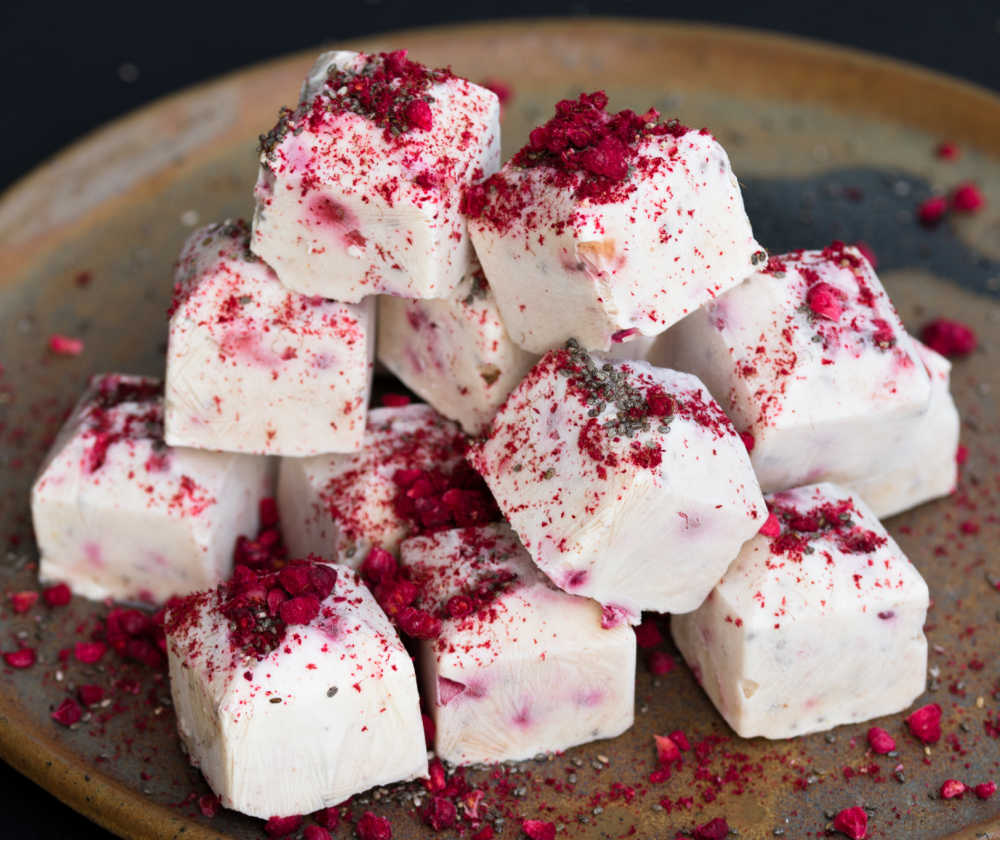 Cubos de iogurte congelado com coberturas de romã.