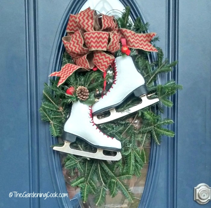 Decoração de porta festiva com patins decorados em uma porta azul.